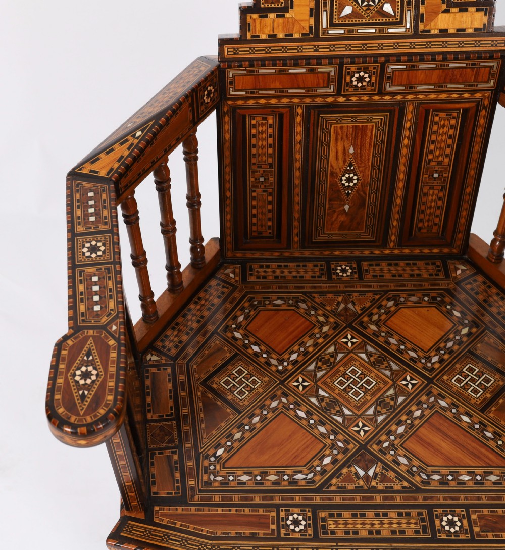 A pair of 19th-century Levantine armchairs decorated with geometric wood parquetry, mother-of-pearl inlay, turned side spindles, and stepped crest rails. View VIII