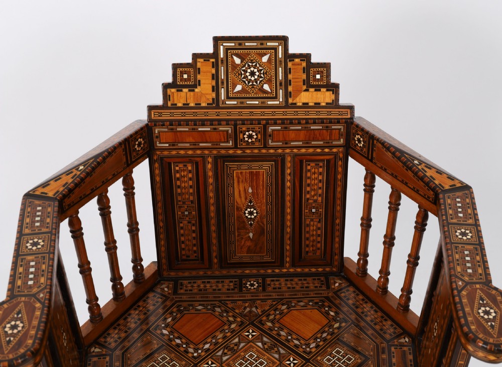 A pair of 19th-century Levantine armchairs decorated with geometric wood parquetry, mother-of-pearl inlay, turned side spindles, and stepped crest rails. View IX