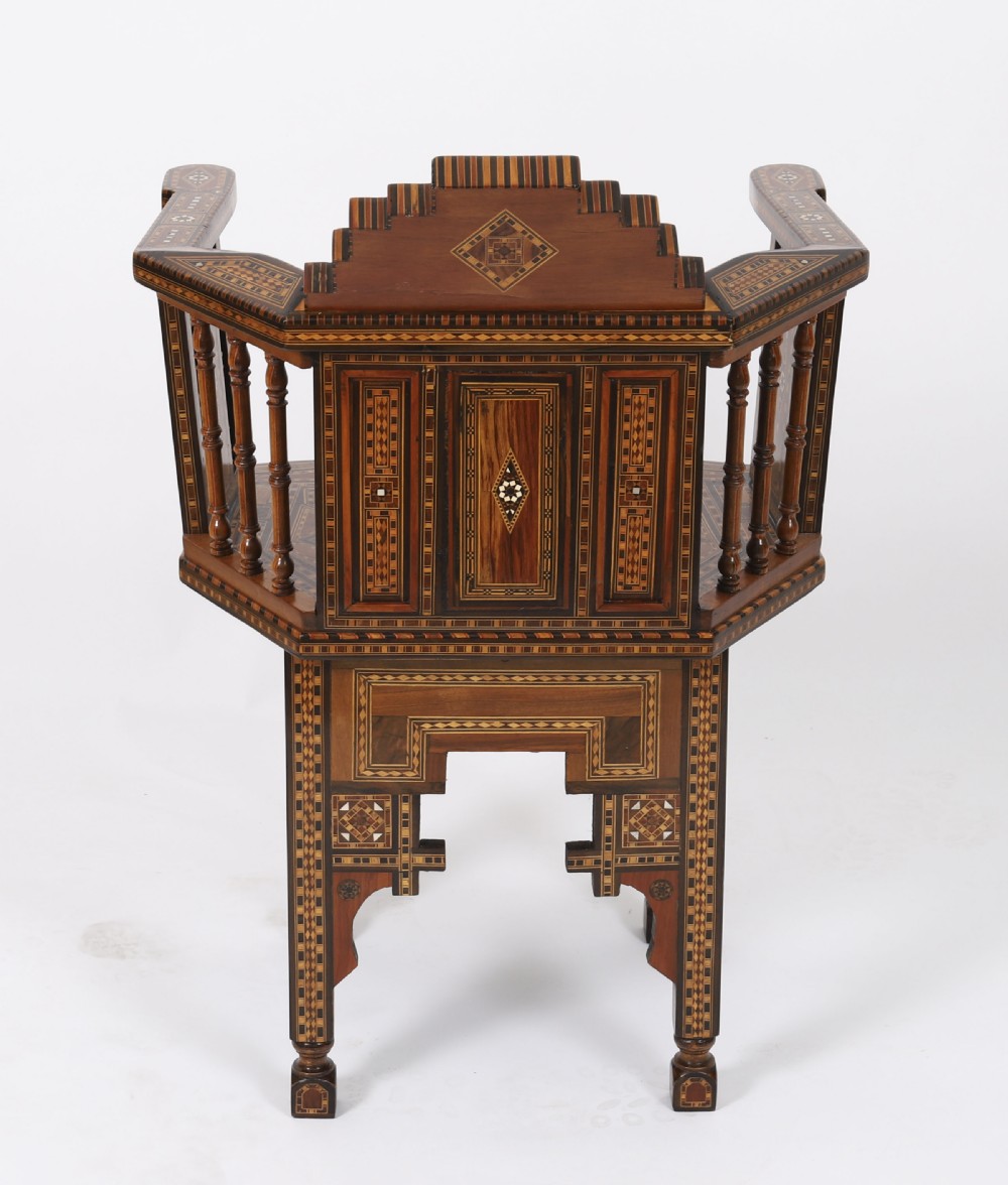 A pair of 19th-century Levantine armchairs decorated with geometric wood parquetry, mother-of-pearl inlay, turned side spindles, and stepped crest rails. View XVII