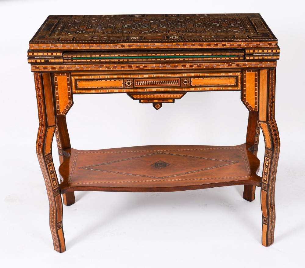 A nineteenth-century wooden games table decorated with geometric micro-mosaic marquetry, mother-of-pearl inlay, cabriole legs, and a lower shelf. View III