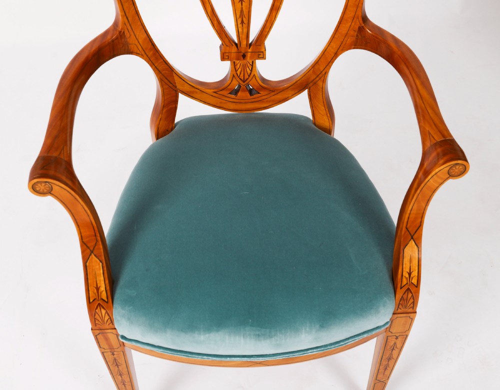 A set of eight antique satinwood shieldback dining chairs featuring classical marquetry inlay and teal velvet seats. View VI