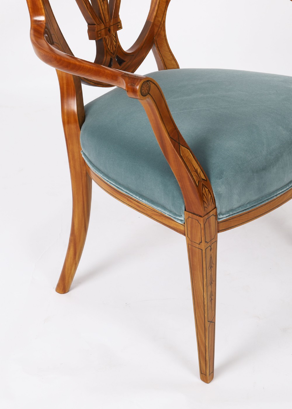 A set of eight antique satinwood shieldback dining chairs featuring classical marquetry inlay and teal velvet seats. View VIII
