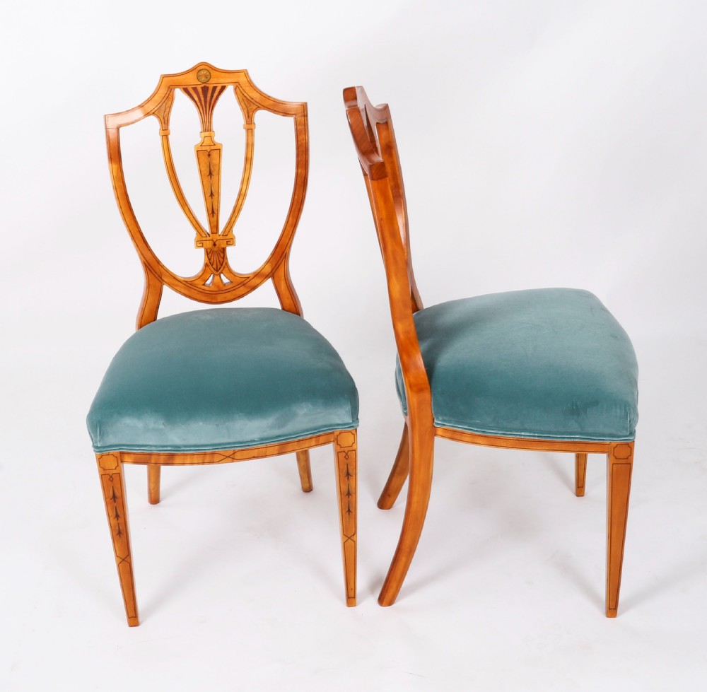 A set of eight antique satinwood shieldback dining chairs featuring classical marquetry inlay and teal velvet seats. View XI