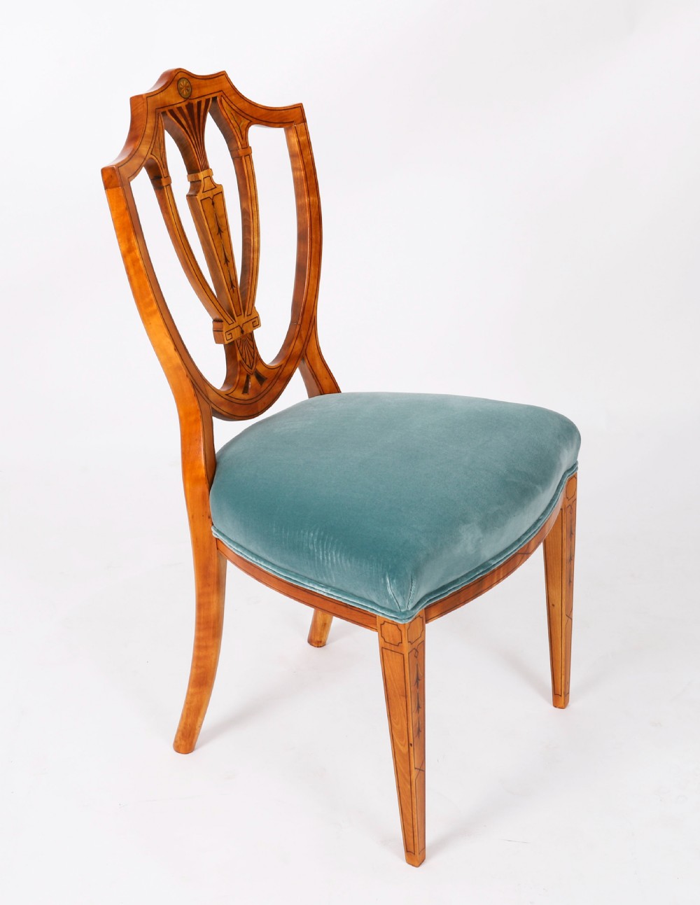 A set of eight antique satinwood shieldback dining chairs featuring classical marquetry inlay and teal velvet seats. View XII