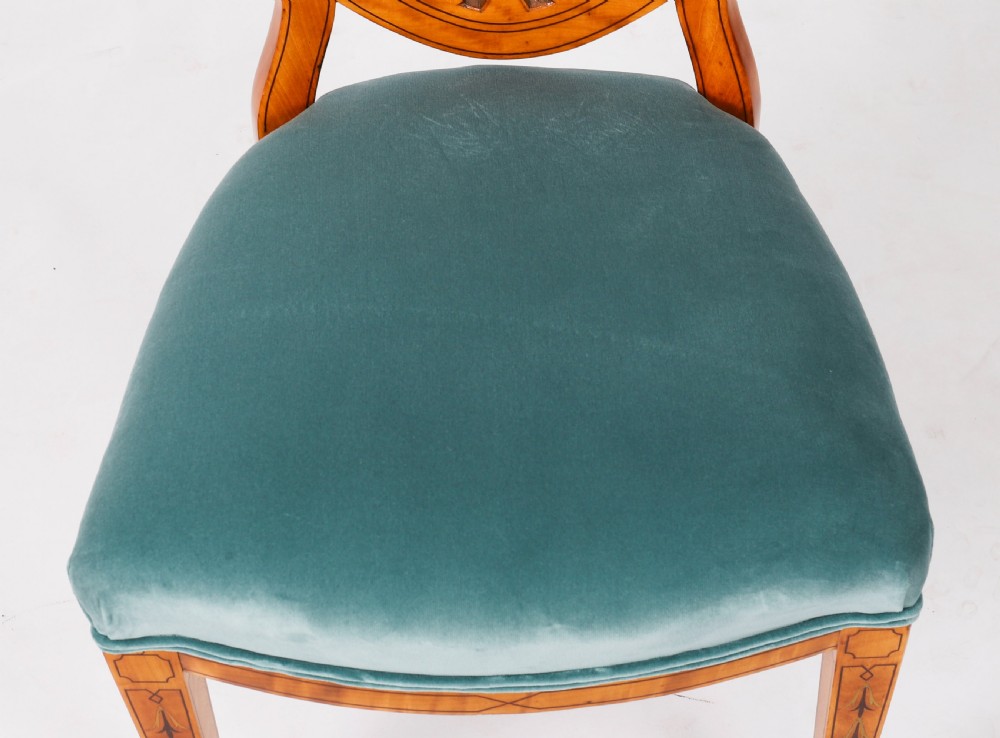 A set of eight antique satinwood shieldback dining chairs featuring classical marquetry inlay and teal velvet seats. View XVIII