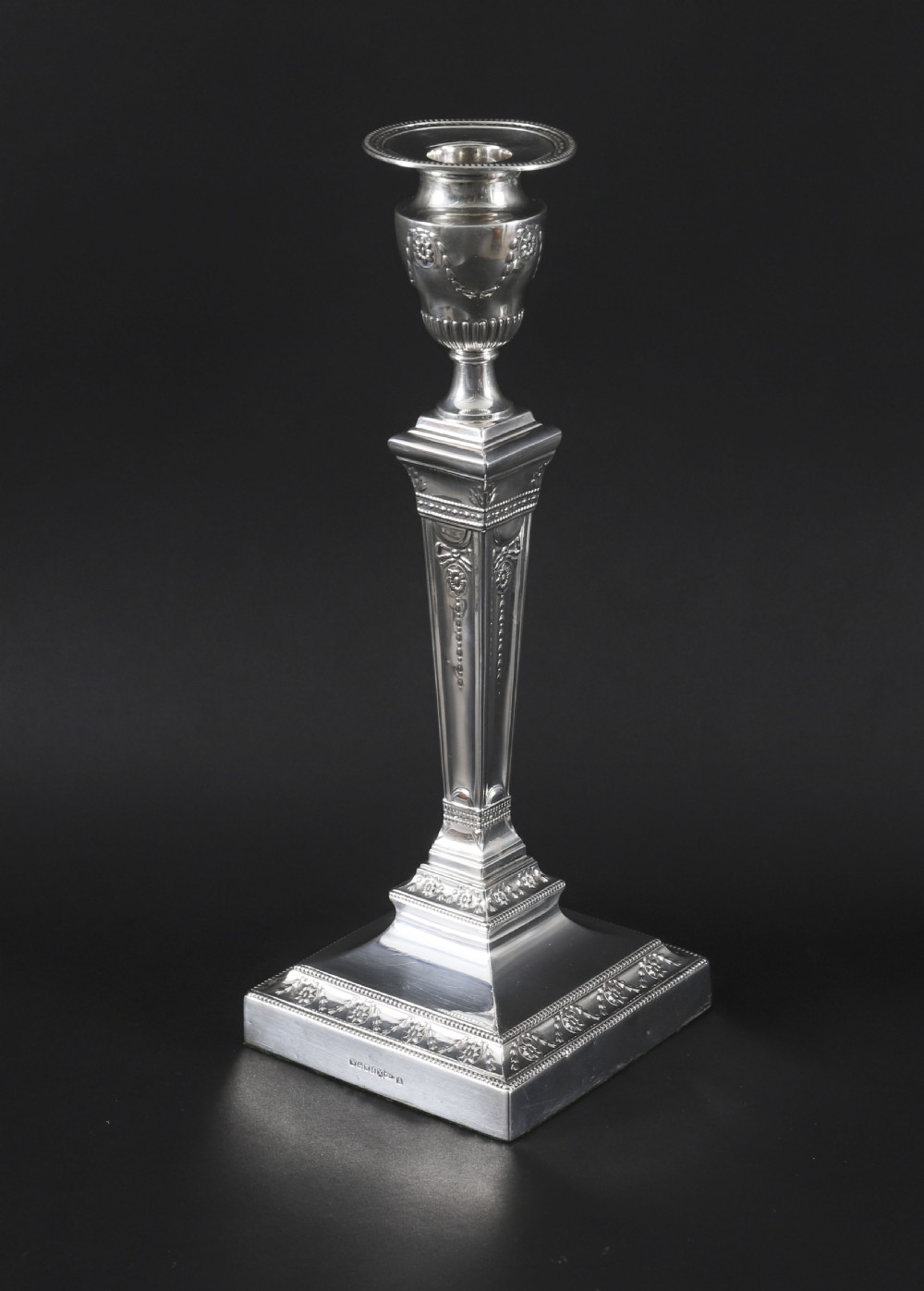 A pair of 19th-century silver-plated Neo-Classical candlesticks with tapered square shafts, urn-shaped nozzles, and festoon decoration on square bases. View III