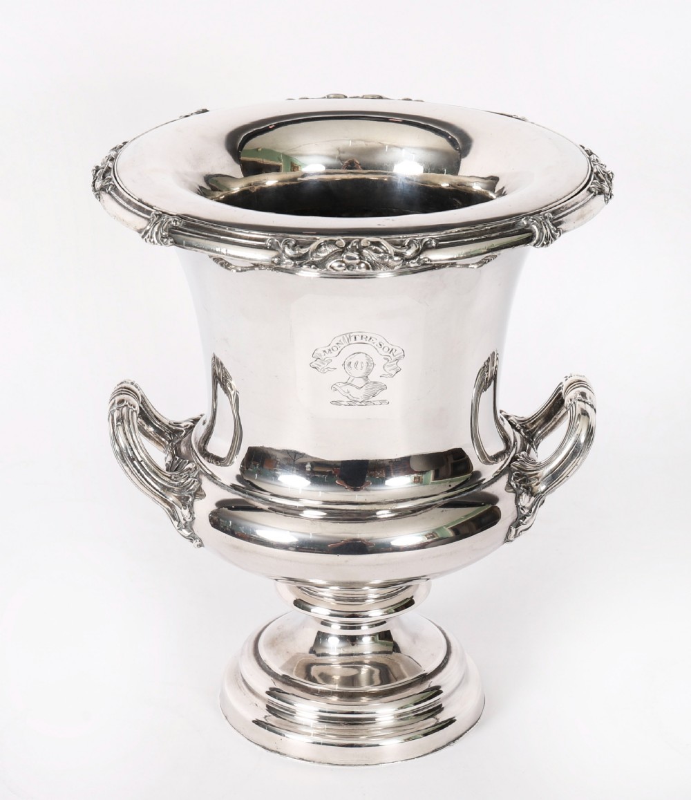 A pair of silver-plated urn-shaped wine coolers featuring scrolled side handles, engraved central crests, and circular pedestal bases. View III