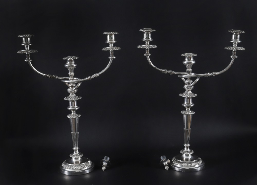 A pair of silver three-light candelabra featuring fluted columns, reeded scrolling branches, and gadrooned rims on circular bases. View II