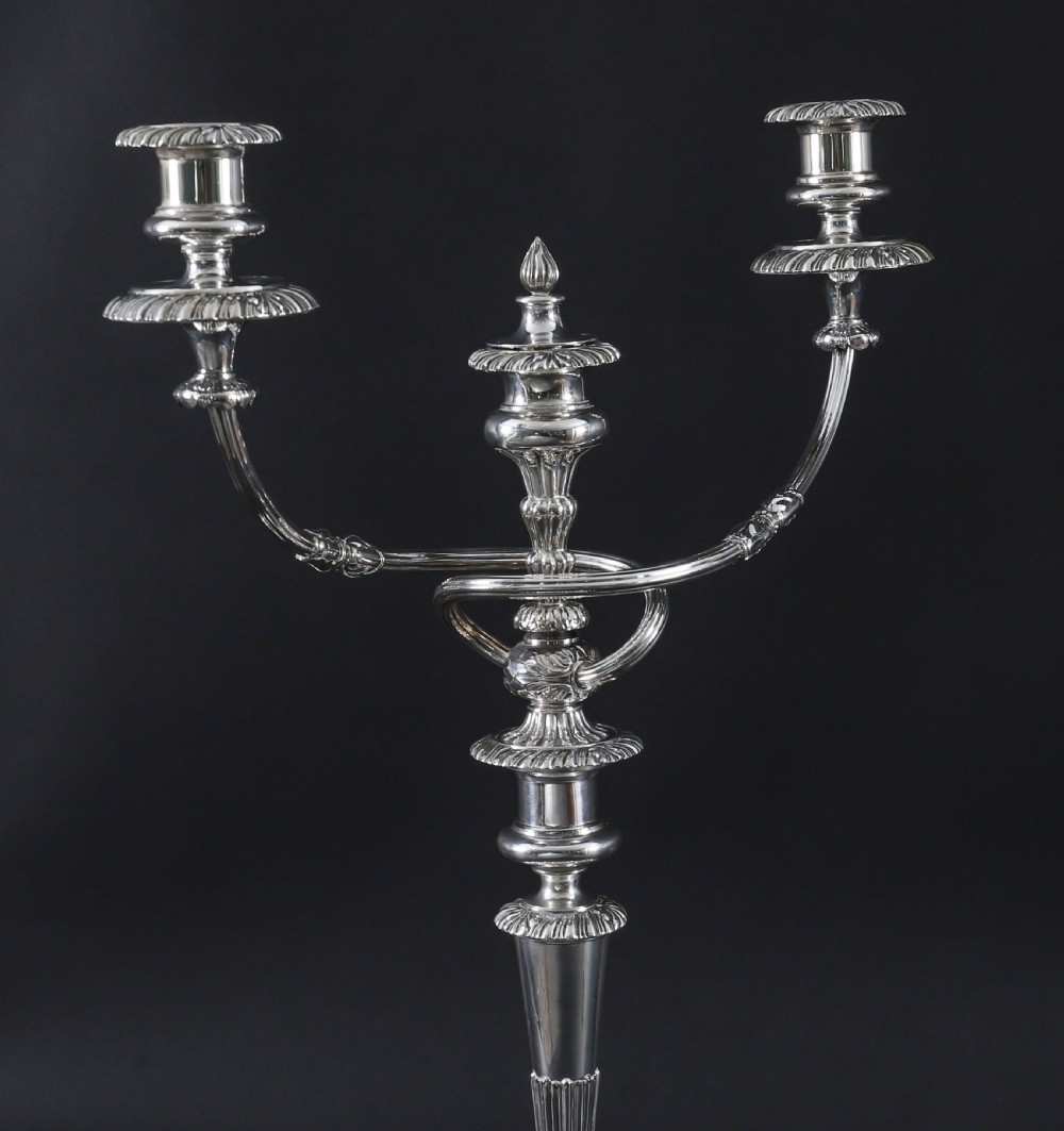 A pair of silver three-light candelabra featuring fluted columns, reeded scrolling branches, and gadrooned rims on circular bases. View V