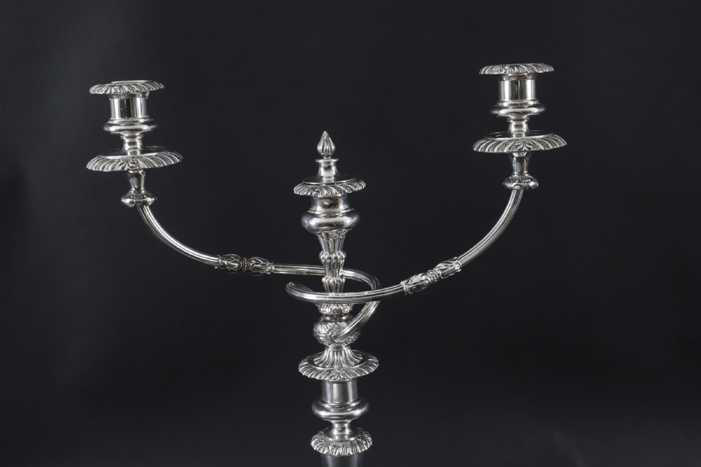 A pair of silver three-light candelabra featuring fluted columns, reeded scrolling branches, and gadrooned rims on circular bases. View VI