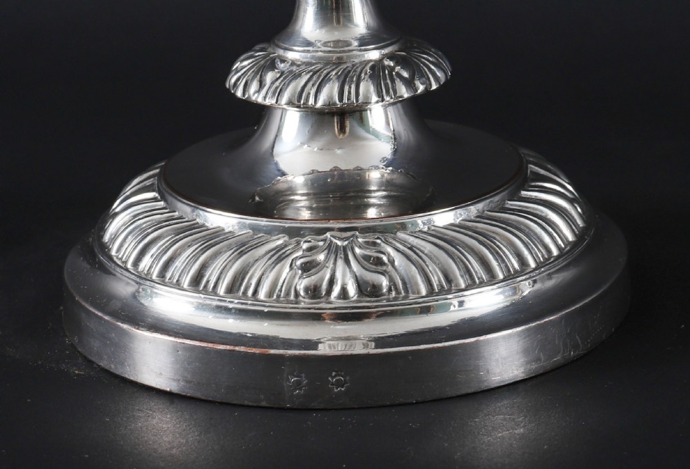 A pair of silver three-light candelabra featuring fluted columns, reeded scrolling branches, and gadrooned rims on circular bases. View XVII