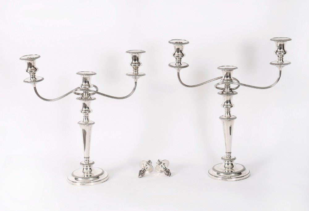 A pair of late nineteenth-century silver three-light candelabra featuring reeded curving arms, beaded circular bases, and central flame finials. View II