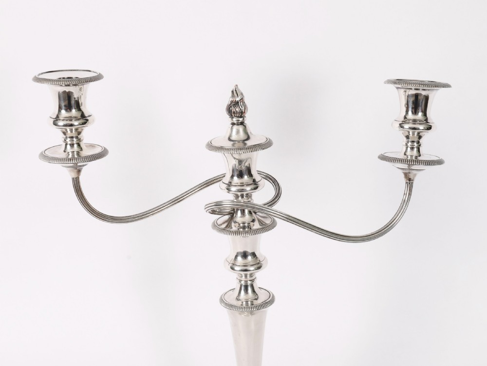 A pair of late nineteenth-century silver three-light candelabra featuring reeded curving arms, beaded circular bases, and central flame finials. View III