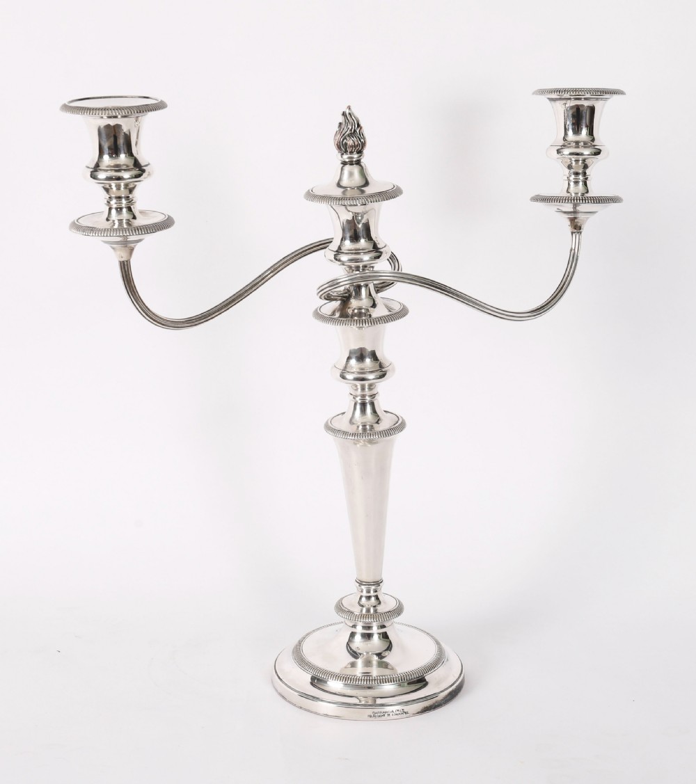 A pair of late nineteenth-century silver three-light candelabra featuring reeded curving arms, beaded circular bases, and central flame finials. View V