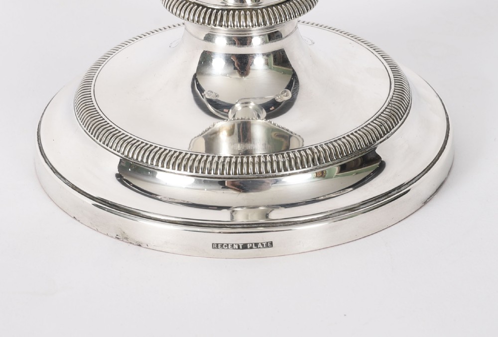A pair of late nineteenth-century silver three-light candelabra featuring reeded curving arms, beaded circular bases, and central flame finials. View VII