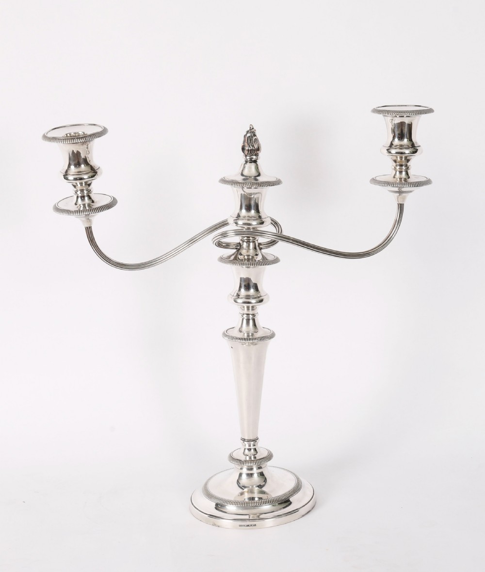 A pair of late nineteenth-century silver three-light candelabra featuring reeded curving arms, beaded circular bases, and central flame finials. View VIII