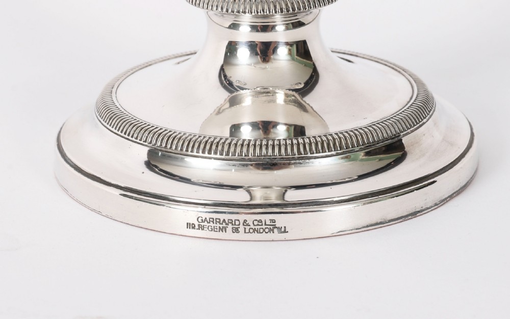 A pair of late nineteenth-century silver three-light candelabra featuring reeded curving arms, beaded circular bases, and central flame finials. View IX