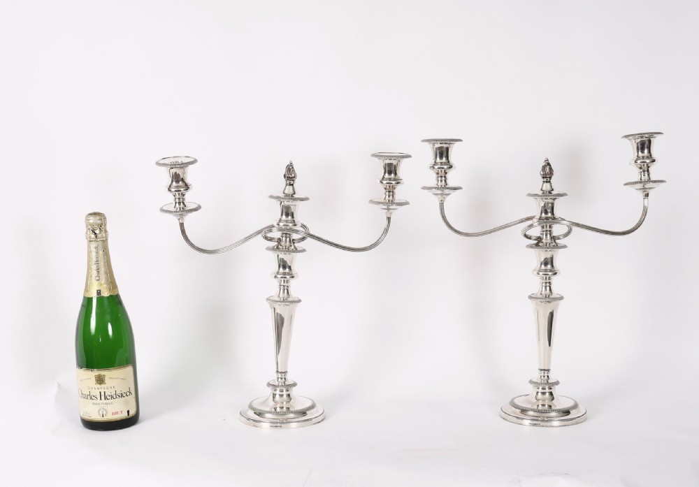 A pair of late nineteenth-century silver three-light candelabra featuring reeded curving arms, beaded circular bases, and central flame finials. View XIX