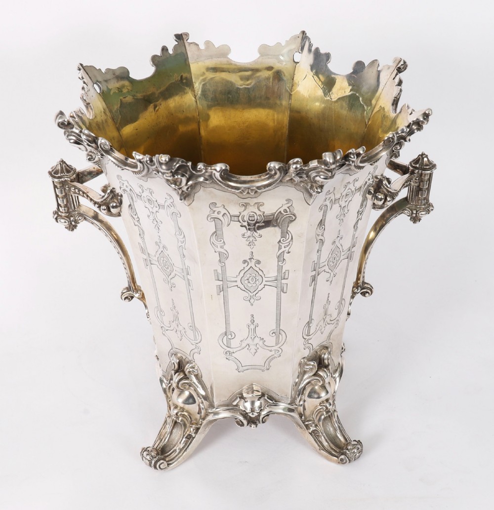 A nineteenth-century silver-plated wine cooler featuring engraved panels, cast scroll feet, side handles, and a gilded interior wash. View II