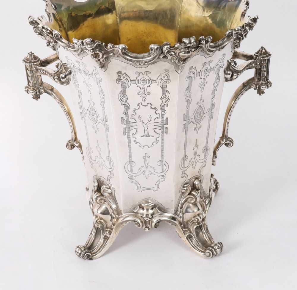 A nineteenth-century silver-plated wine cooler featuring engraved panels, cast scroll feet, side handles, and a gilded interior wash. View III
