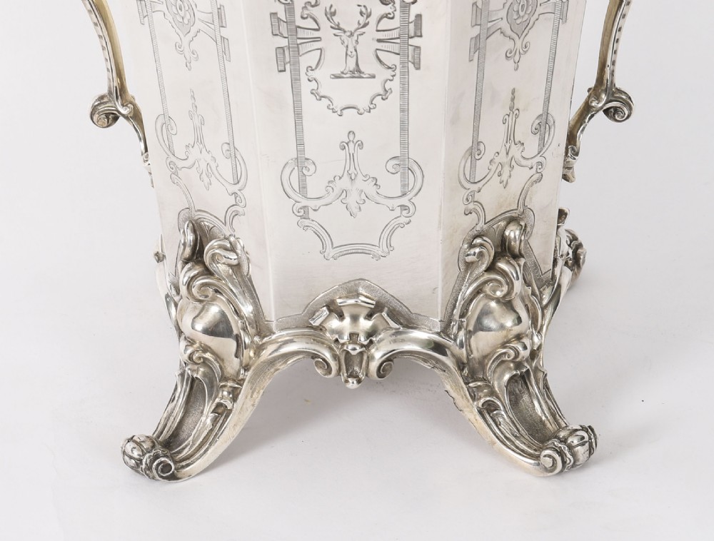 A nineteenth-century silver-plated wine cooler featuring engraved panels, cast scroll feet, side handles, and a gilded interior wash. View VII