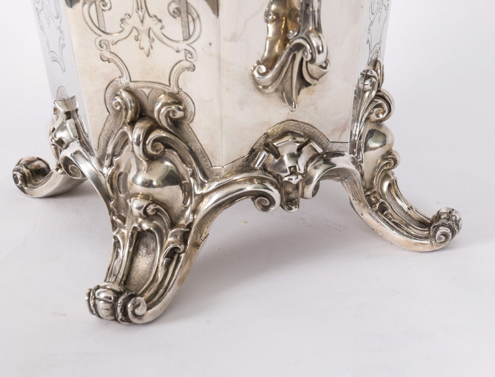 A nineteenth-century silver-plated wine cooler featuring engraved panels, cast scroll feet, side handles, and a gilded interior wash. View XI