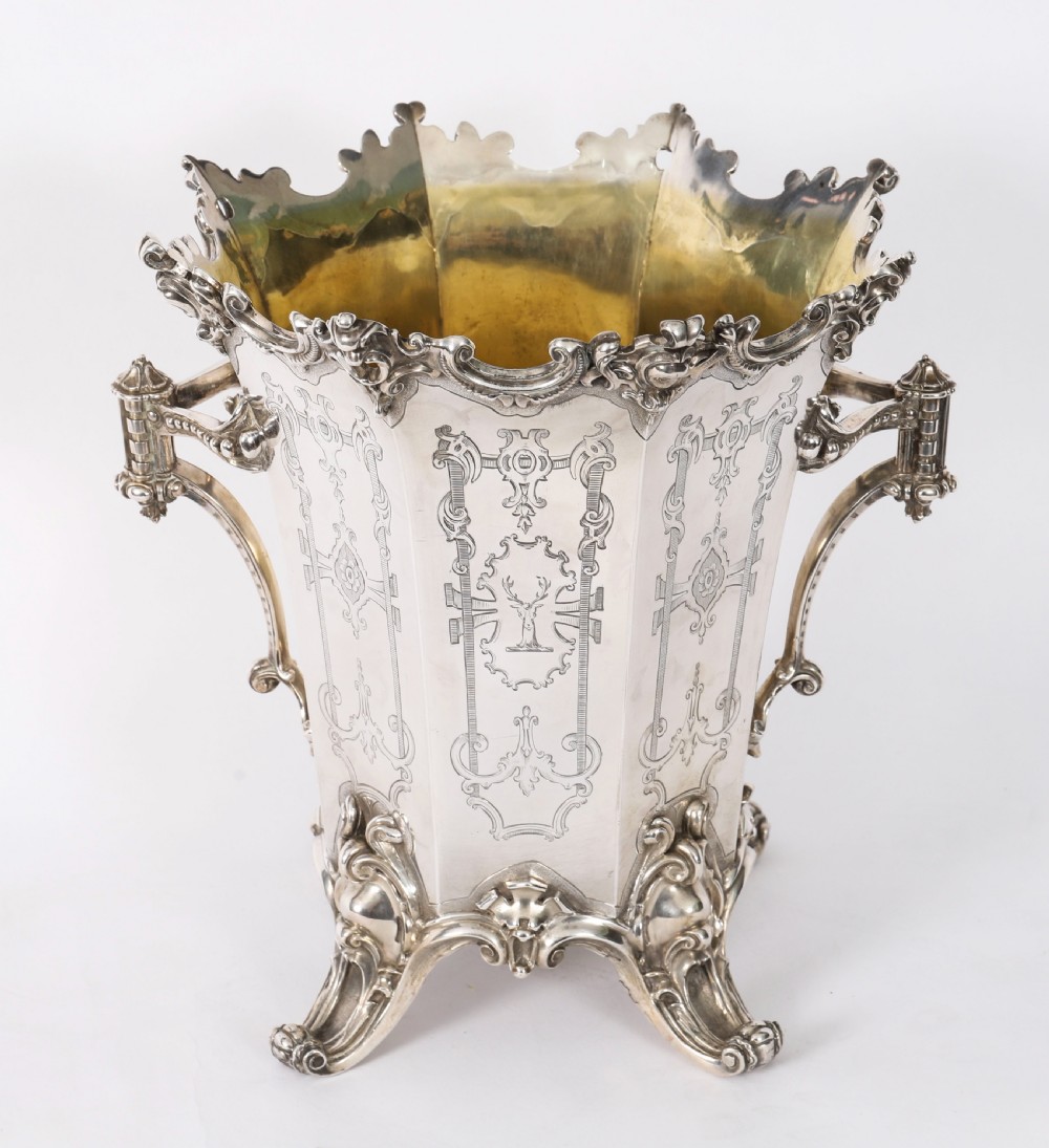 A nineteenth-century silver-plated wine cooler featuring engraved panels, cast scroll feet, side handles, and a gilded interior wash. View XII