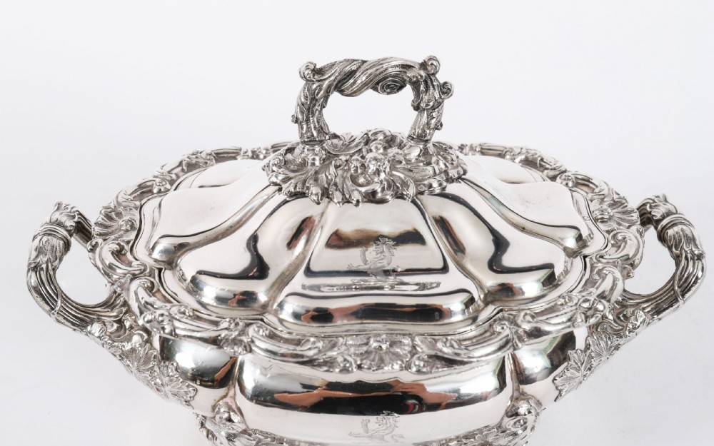 A pair of silver-plated oval sauce tureens featuring domed lids, foliate scroll handles, and decorative carved feet. View IV