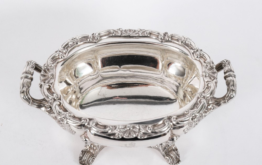 A pair of silver-plated oval sauce tureens featuring domed lids, foliate scroll handles, and decorative carved feet. View VIII
