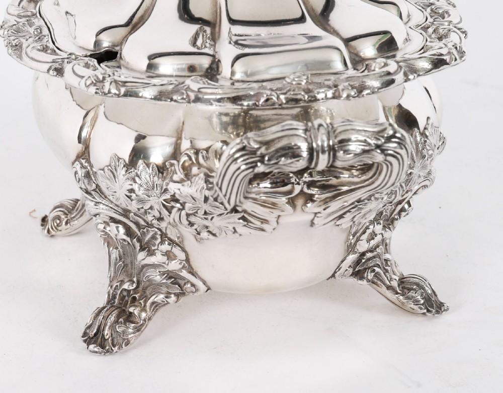 A pair of silver-plated oval sauce tureens featuring domed lids, foliate scroll handles, and decorative carved feet. View XII
