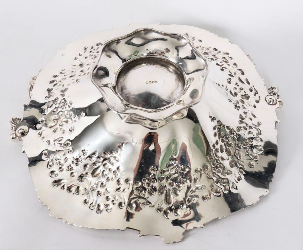 An ornate mid-19th-century Victorian silver-plated fruit basket with a high scroll swing handle, chased leaf patterns, scalloped rim, and pedestal base. View VIII