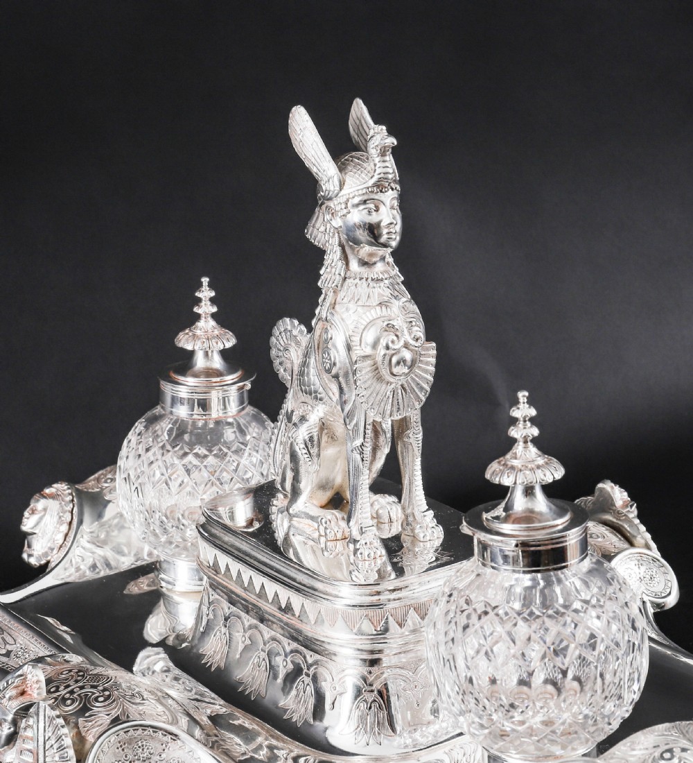 A Victorian silver-plated inkstand featuring a central winged sphinx sculpture flanked by two cut glass inkwell bottles. View III