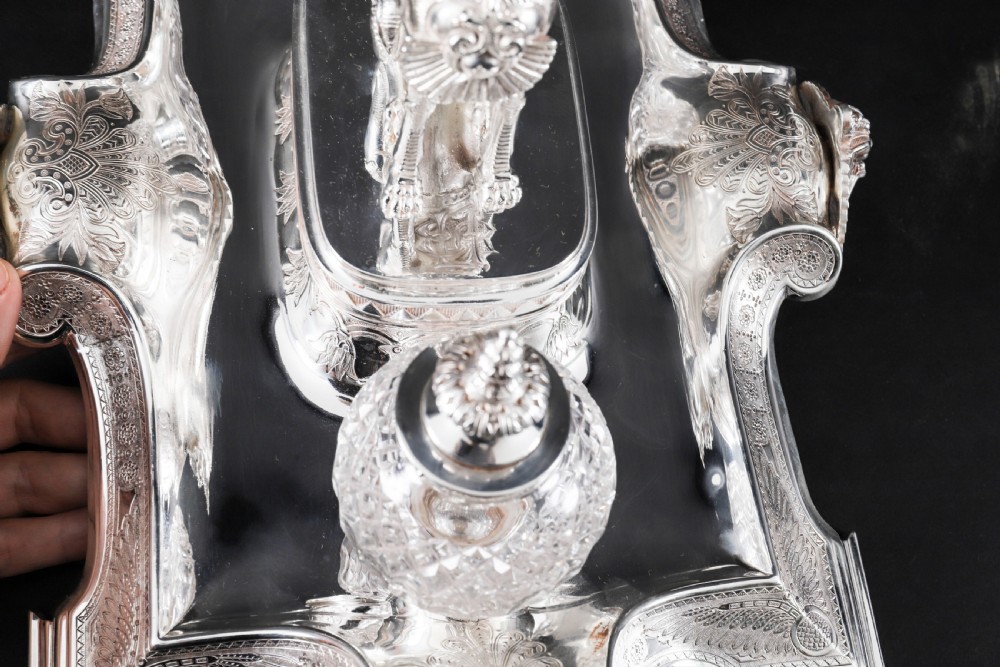 A Victorian silver-plated inkstand featuring a central winged sphinx sculpture flanked by two cut glass inkwell bottles. View IV