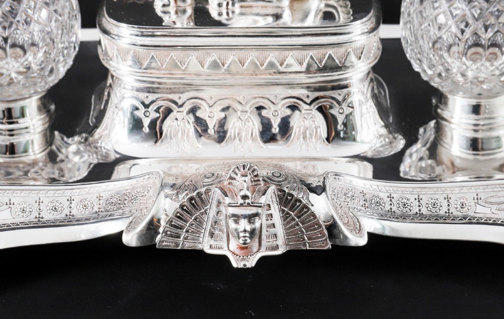 A Victorian silver-plated inkstand featuring a central winged sphinx sculpture flanked by two cut glass inkwell bottles. View XI
