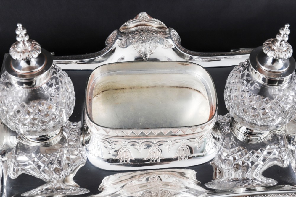 A Victorian silver-plated inkstand featuring a central winged sphinx sculpture flanked by two cut glass inkwell bottles. View XIV