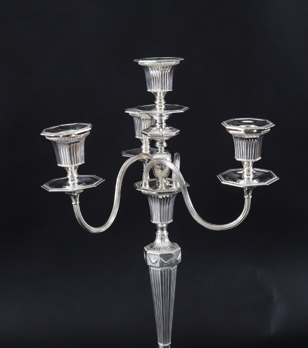 A pair of silver-plated four-light candelabra featuring fluted tapered stems, octagonal stepped bases, and curved reeded arms. View IV