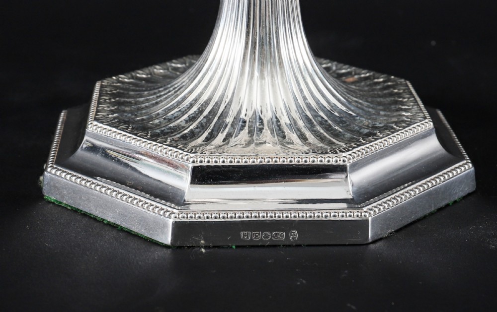 A pair of silver-plated four-light candelabra featuring fluted tapered stems, octagonal stepped bases, and curved reeded arms. View XV