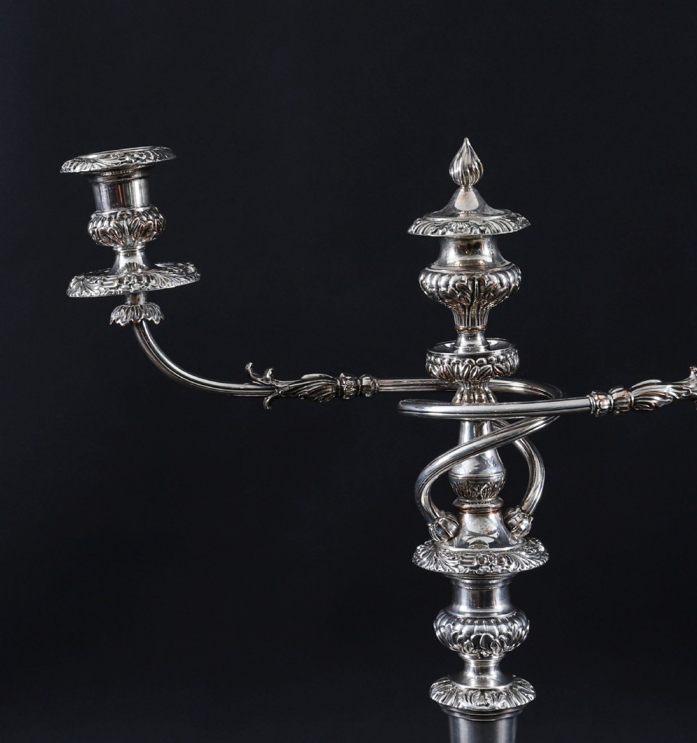 A four-piece set of 18th-century George III Old Sheffield silver-plated candelabra and matching candlesticks with fluted stems and leaf motifs. View IV