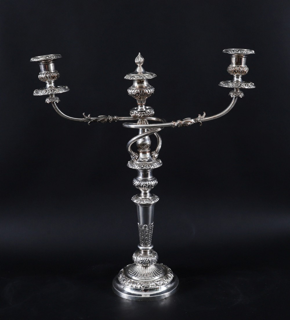 A four-piece set of 18th-century George III Old Sheffield silver-plated candelabra and matching candlesticks with fluted stems and leaf motifs. View V