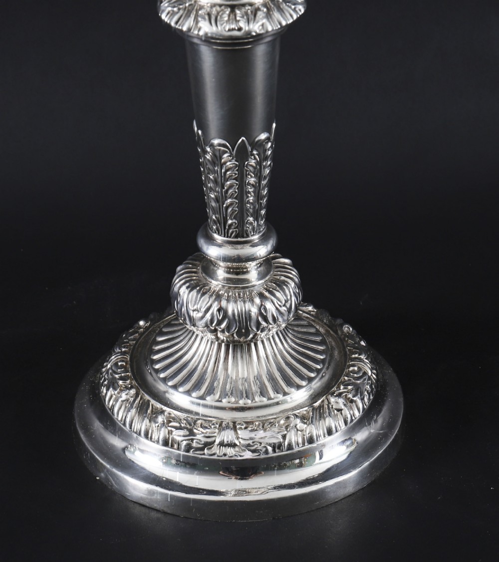 A four-piece set of 18th-century George III Old Sheffield silver-plated candelabra and matching candlesticks with fluted stems and leaf motifs. View VI