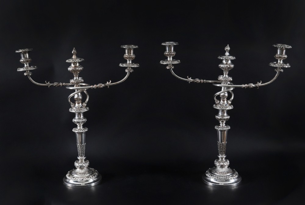 A four-piece set of 18th-century George III Old Sheffield silver-plated candelabra and matching candlesticks with fluted stems and leaf motifs. View VII