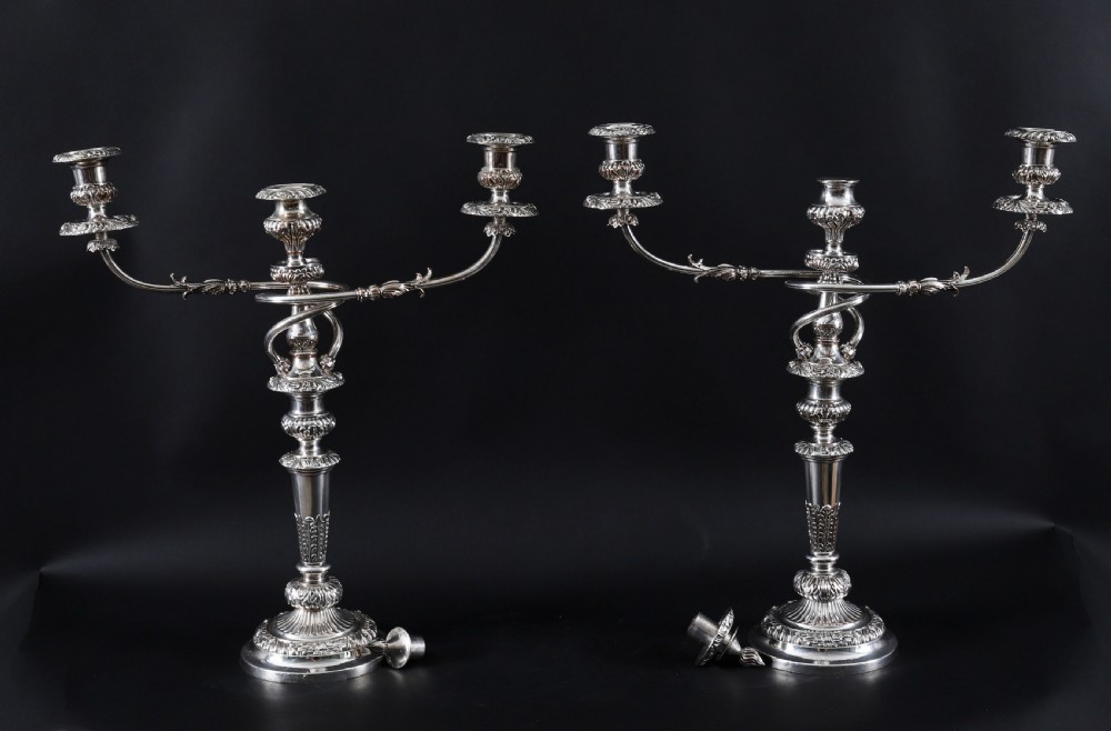 A four-piece set of 18th-century George III Old Sheffield silver-plated candelabra and matching candlesticks with fluted stems and leaf motifs. View IX