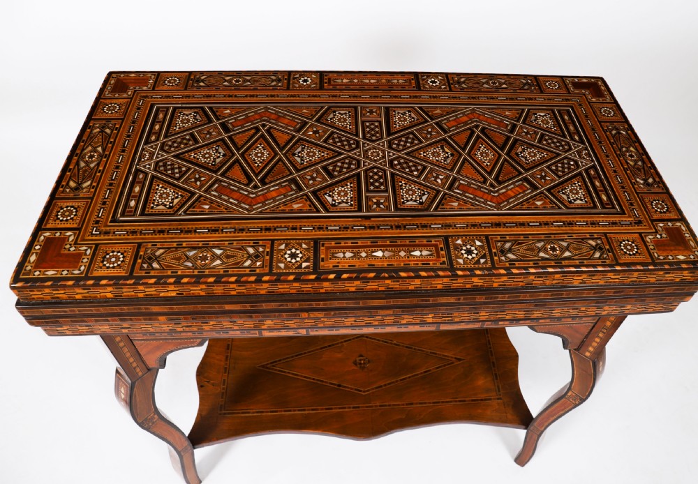 An antique Levantine folding games table featuring geometric marquetry and bone inlays on cabriole legs with a lower shelf. View VI