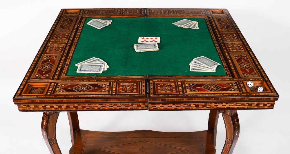 An antique Levantine folding games table featuring geometric marquetry and bone inlays on cabriole legs with a lower shelf. View VII
