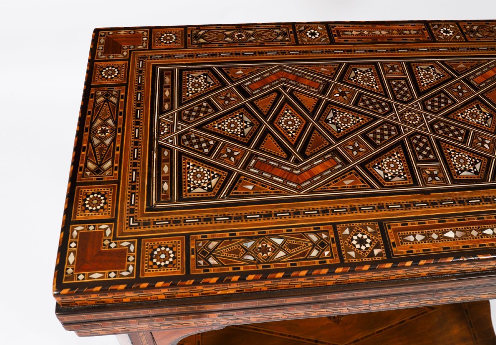An antique Levantine folding games table featuring geometric marquetry and bone inlays on cabriole legs with a lower shelf. View IX