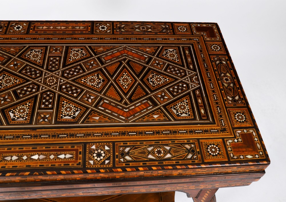 An antique Levantine folding games table featuring geometric marquetry and bone inlays on cabriole legs with a lower shelf. View XI