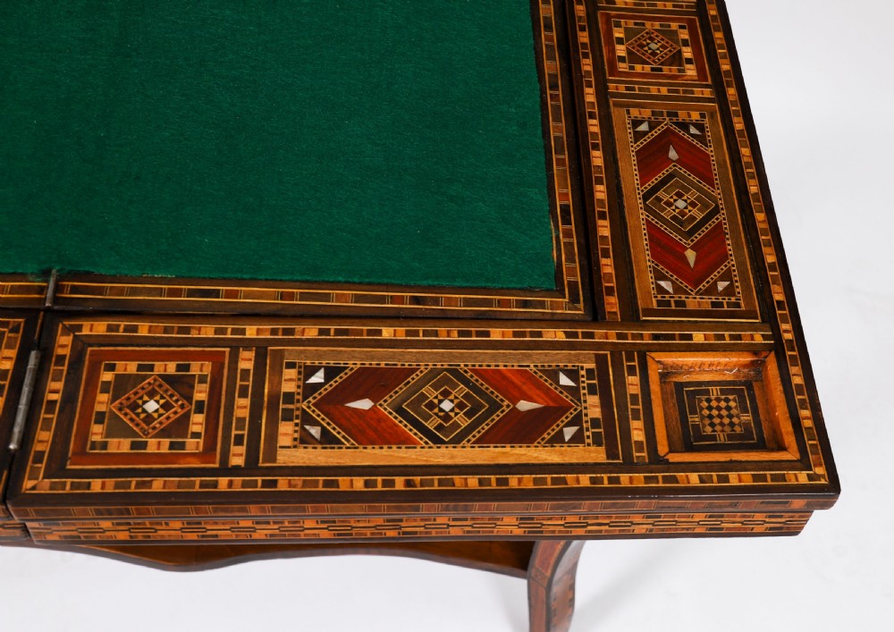 An antique Levantine folding games table featuring geometric marquetry and bone inlays on cabriole legs with a lower shelf. View XIV