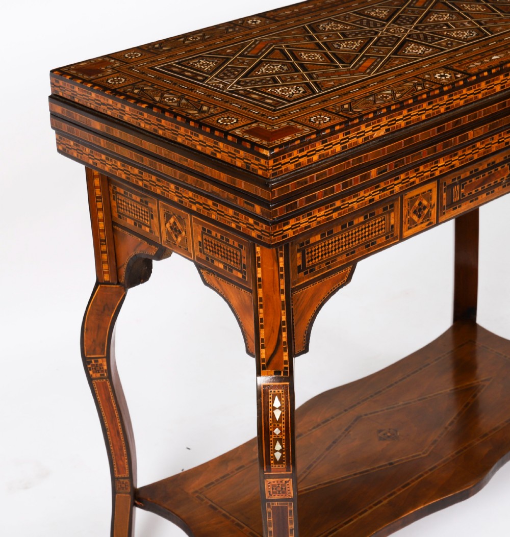An antique Levantine folding games table featuring geometric marquetry and bone inlays on cabriole legs with a lower shelf. View XVI