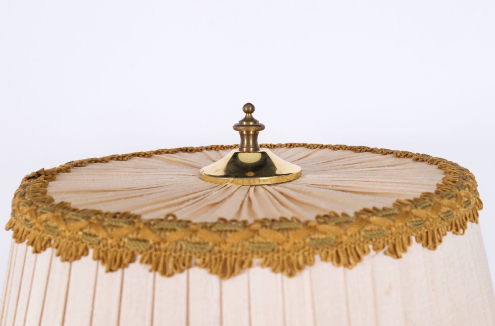 A pair of Neoclassical ormolu urn-form table lamps featuring classical figures mounted on square pink marble bases with cream pleated shades. View XI