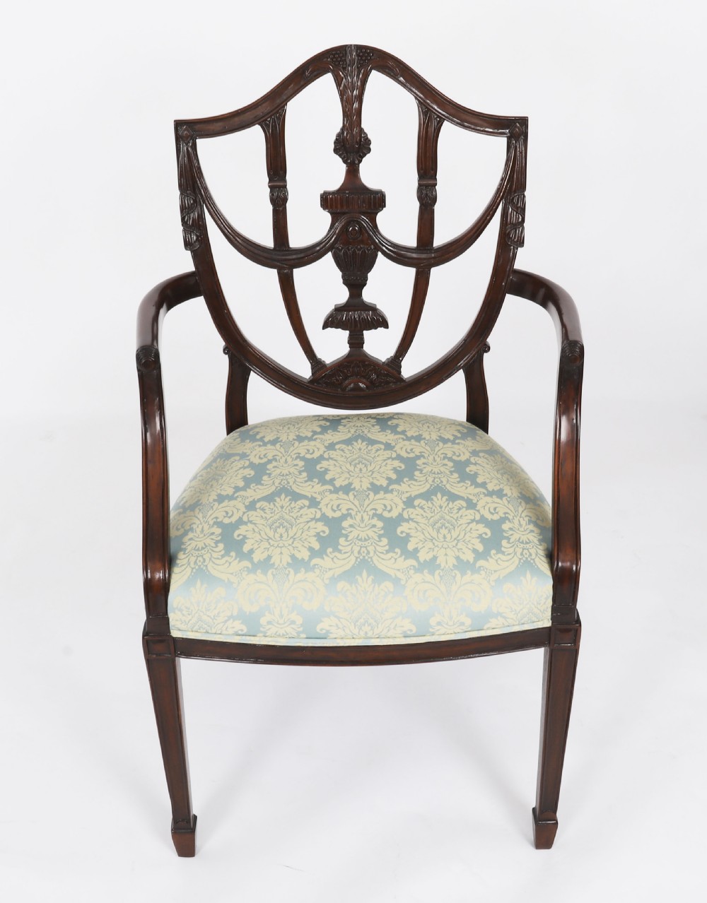 A pair of 20th-century mahogany Federal Revival armchairs featuring carved shield backs with central urn splats and blue patterned damask seats. View X